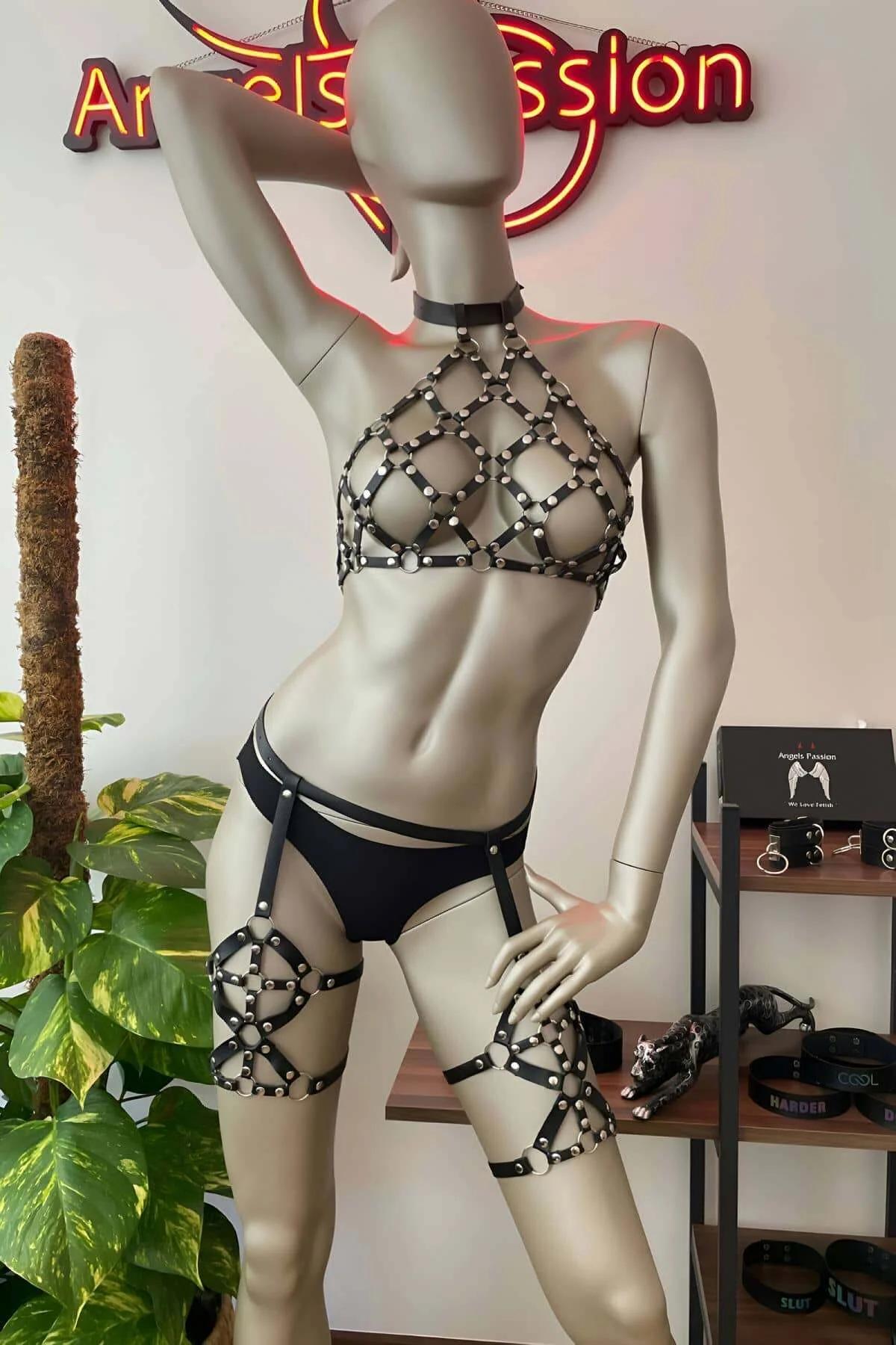 Black faux leather studded cage halter harness with silver dome rivets and matching thigh garter bands on mannequin