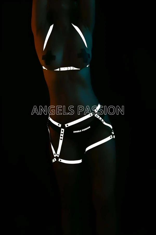 Black reflective body harness set with silver O-ring accents glowing under low light, two-piece chest and shorts style