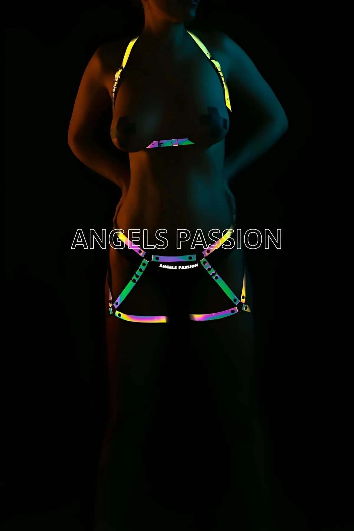 Iridescent rainbow reflective body harness set glowing green yellow pink teal on dark background, two-piece chest and waist h
