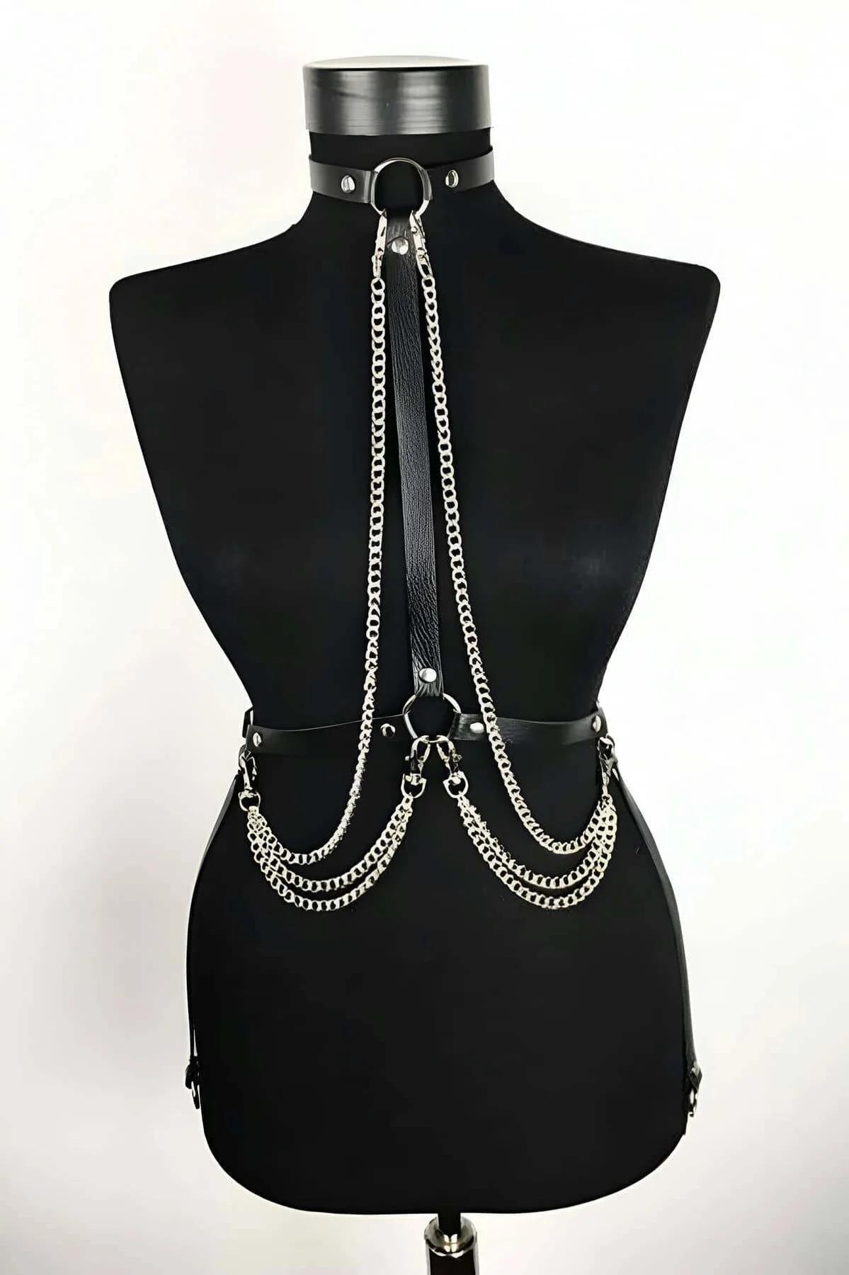 Black faux leather choker body harness with three draped silver curb chains and O-ring hardware on mannequin