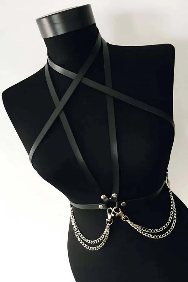 Black faux leather full body harness with X-cross chest straps and double-row silver chains at waist on mannequin