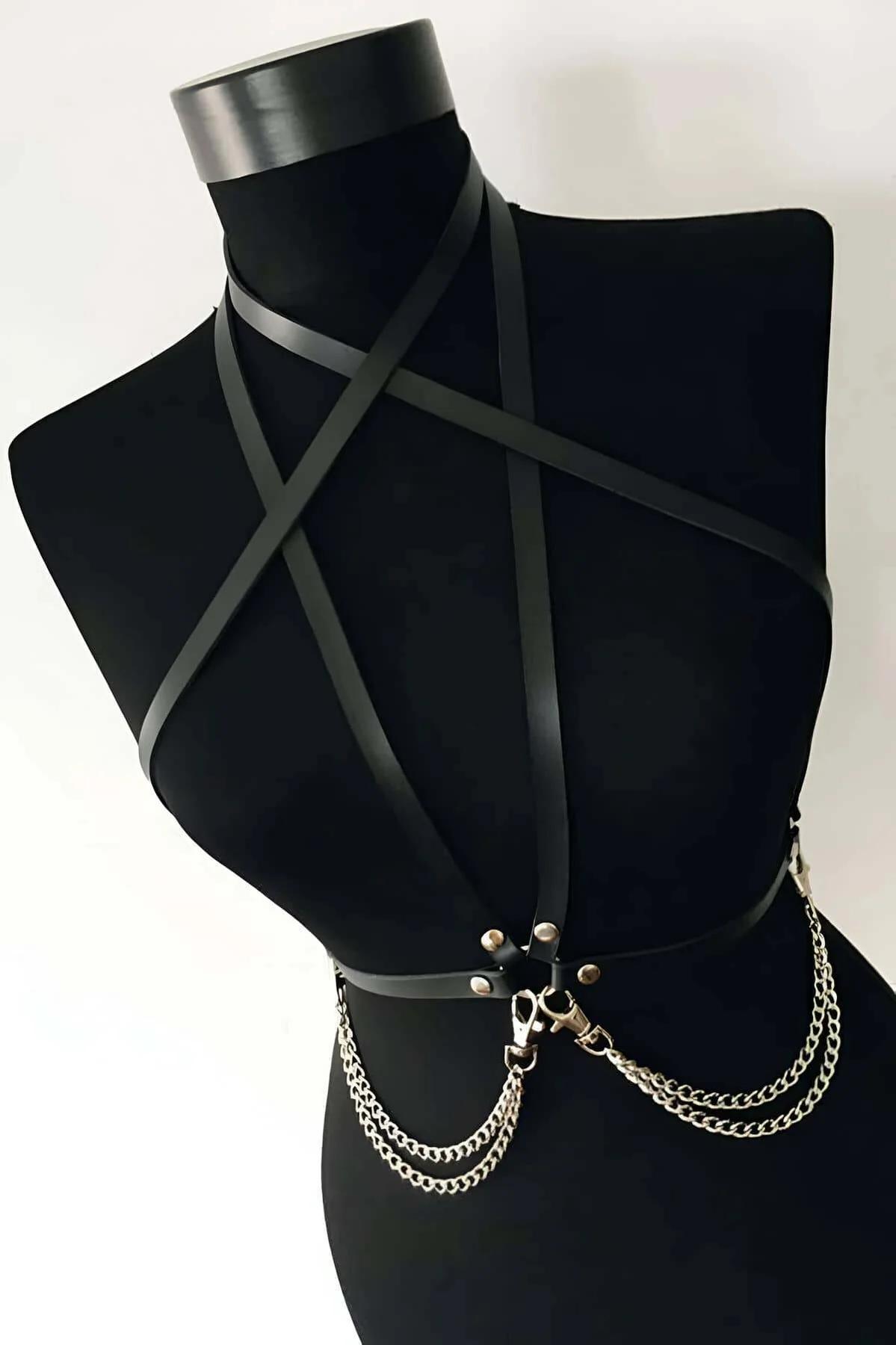 Black faux leather full body harness with X-cross chest straps and double-row silver chains at waist on mannequin