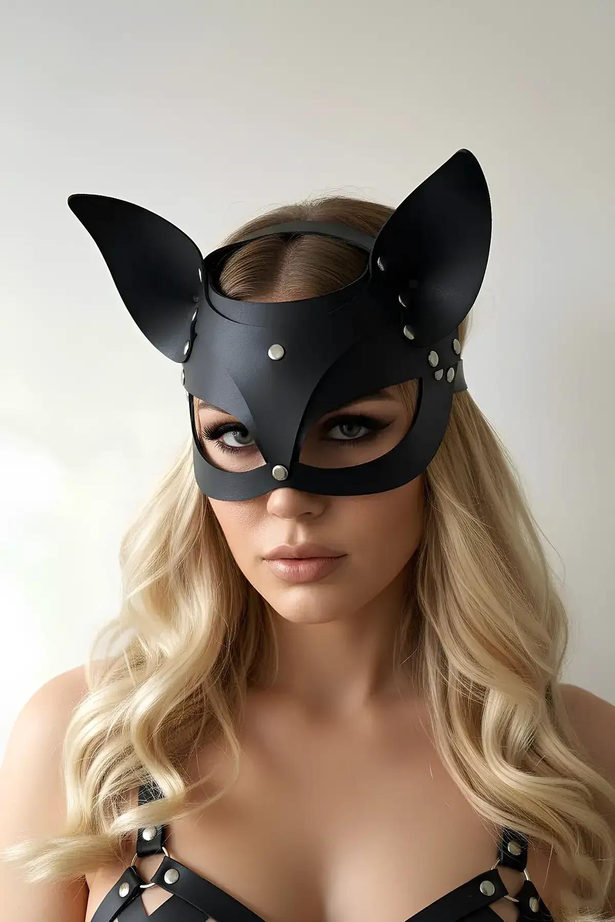 Black faux leather cat mask with pointed ears and silver dome studs worn on face, matte finish, front view