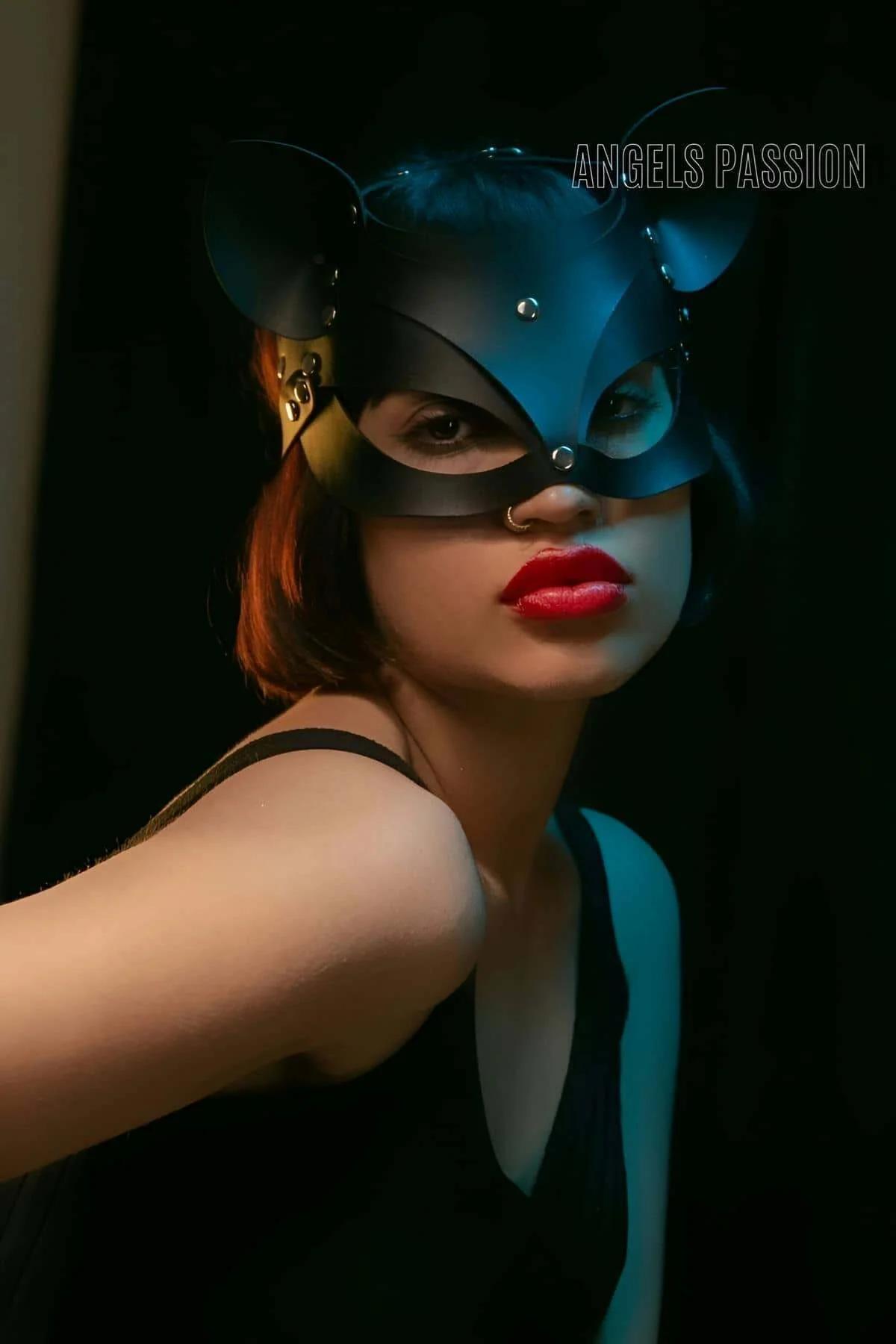 Black faux leather cat mask with structured pointed ears and silver dome studs, gold-tone buckle hardware on sides