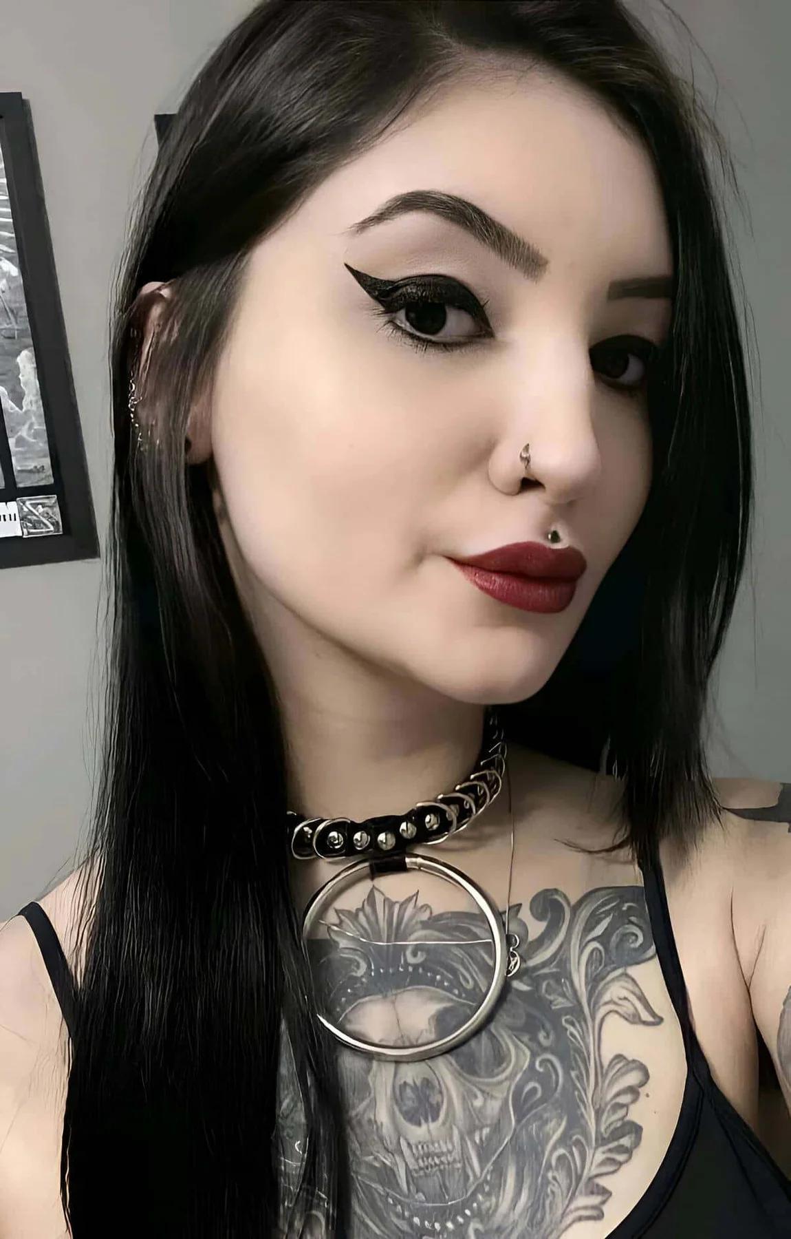 Black rubber choker with silver dome studs and large silver O-ring worn at the neck, gothic streetwear style