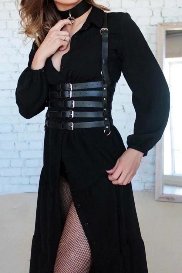 black faux leather multi-strap corset body harness with silver buckles and O-ring choker worn over black shirt dress