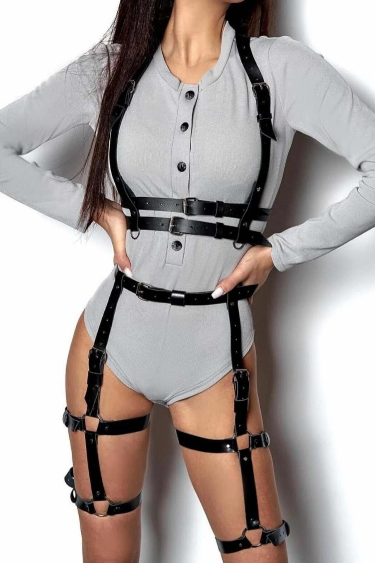 black faux leather full body harness with layered chest straps double waist band and dual thigh garter rings worn over grey b