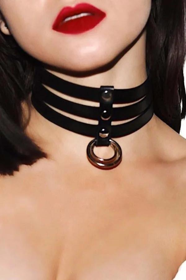 Black faux leather triple-strap O-ring choker necklace with gold-tone metal ring pendant worn around neck