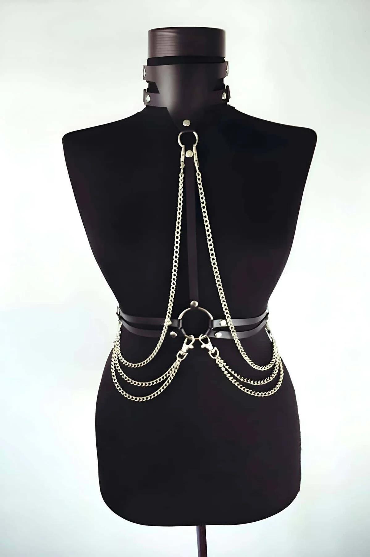 Black faux leather full body harness with three cascading gold-tone curb-link chains connecting choker to waist O-ring band