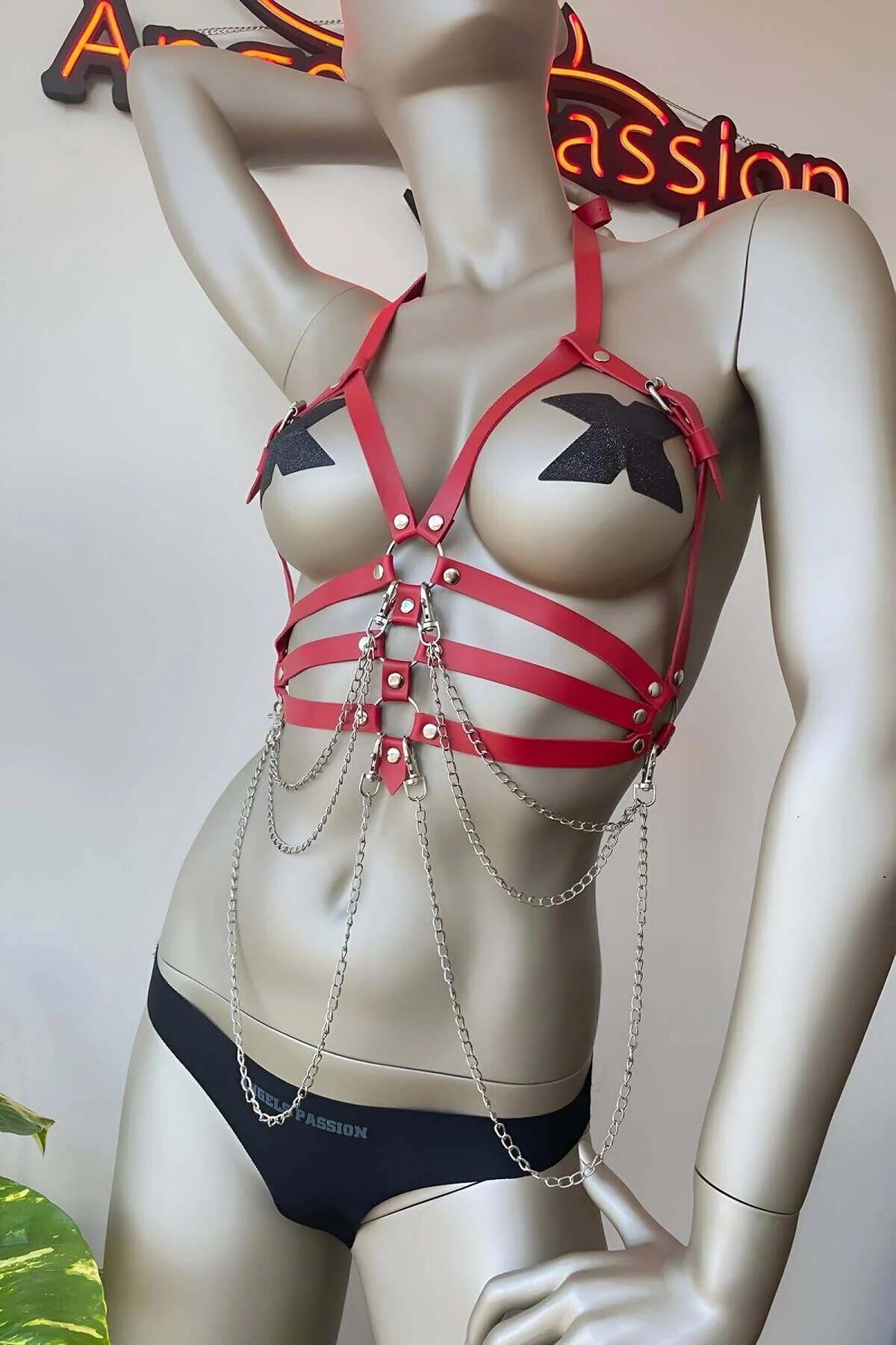 Red faux leather chest harness with multi-row straps silver-tone O-ring and cascading draping chains on mannequin