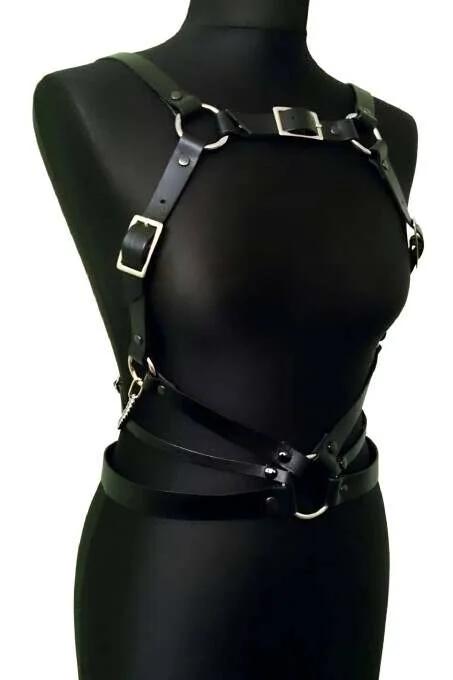 black faux leather full body harness with silver O-rings and adjustable buckle straps on mannequin front view