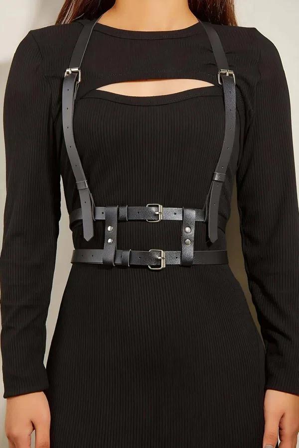 Black faux leather double belt chest harness with silver-tone buckles and adjustable shoulder straps worn over black ribbed d