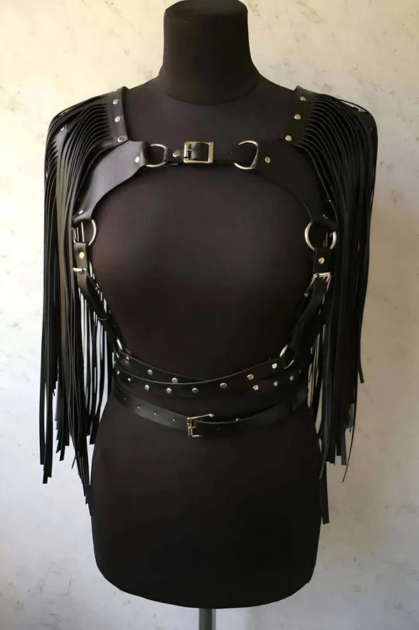 black faux leather fringe body harness with silver O-rings and studded waist belt on mannequin