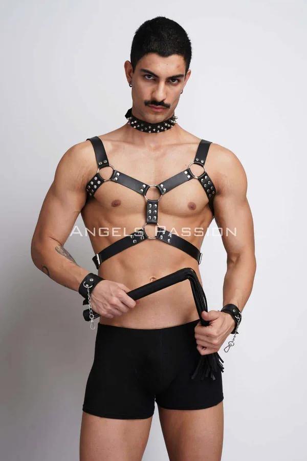 Black faux leather chest harness with silver O-rings, spiked choker and chain wrist cuffs worn by male model