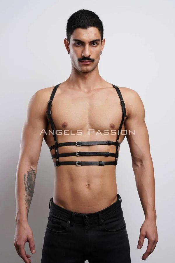 Black faux leather strappy chest harness with three silver-tone rectangular buckles worn by male model