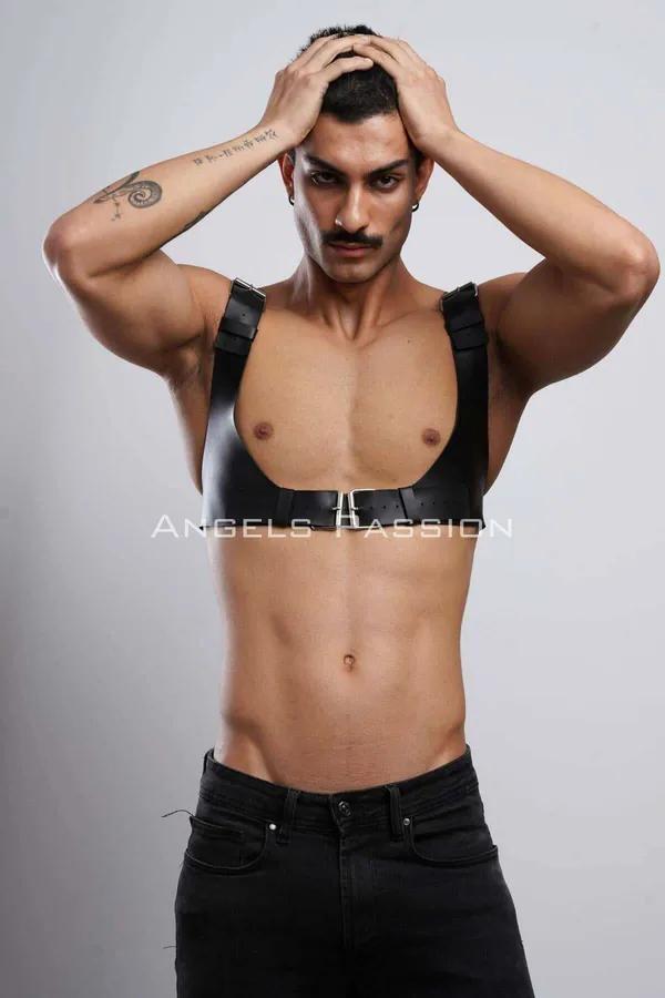 Black faux leather chest harness with silver buckle on male model, matte finish shoulder straps and central adjustment band