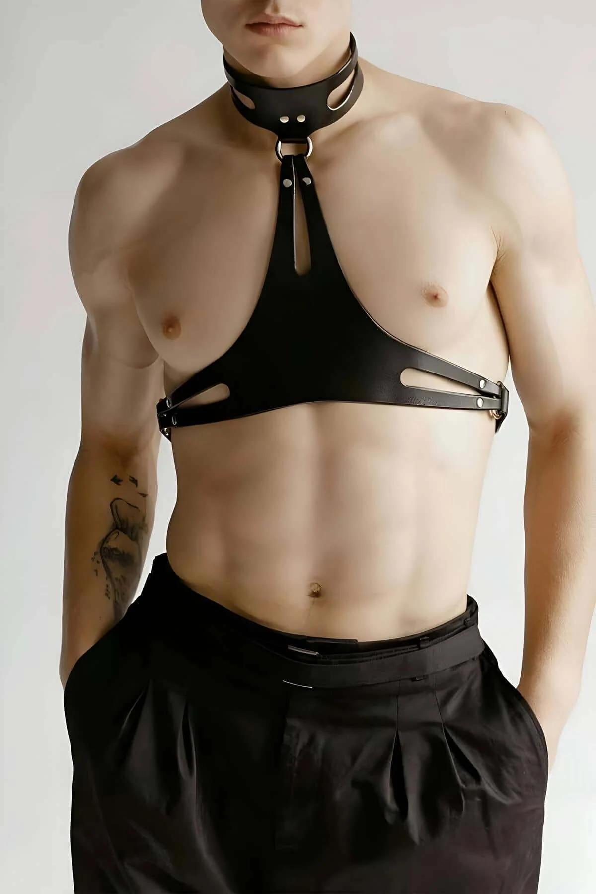 Black faux leather chest harness with cut-out choker collar, triangular panel, silver O-ring and dome rivets, worn by male mo