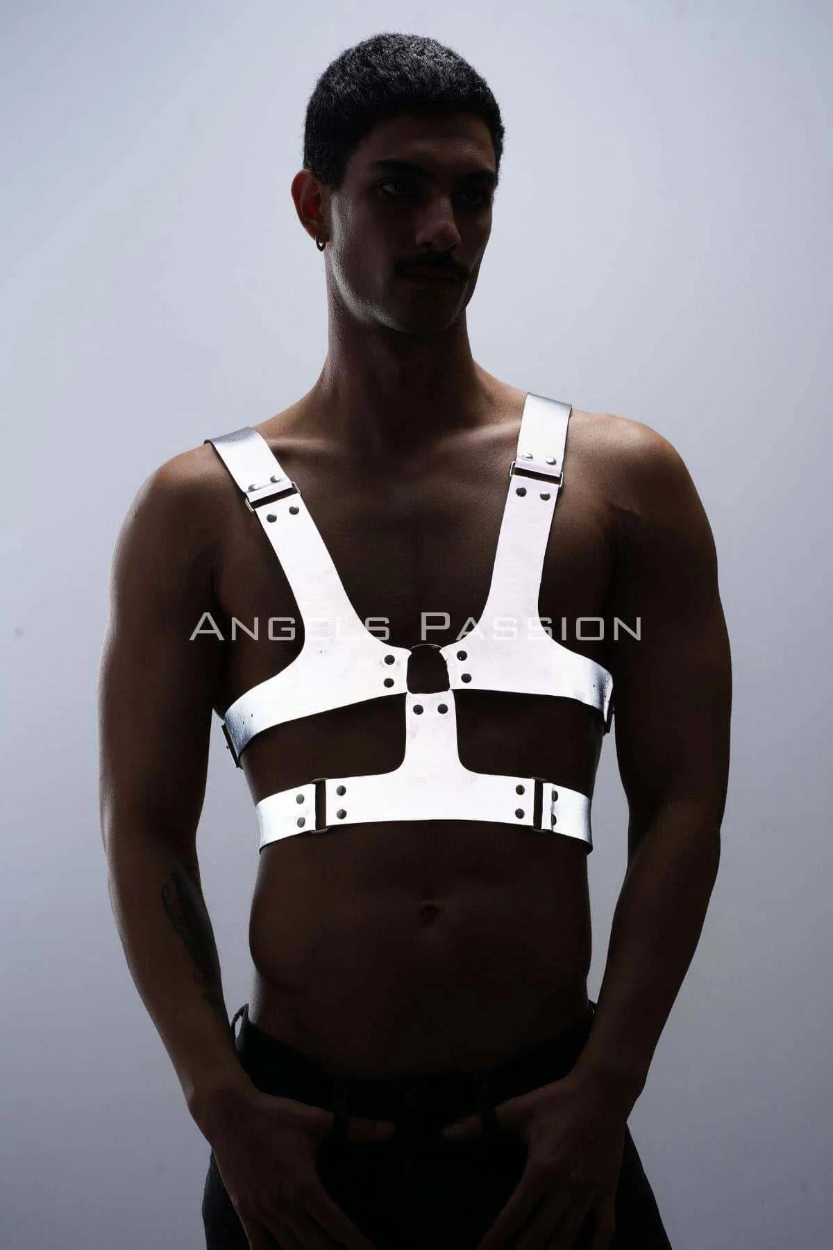 Reflective white chest harness with wide adjustable straps and silver rivets worn by a man front view