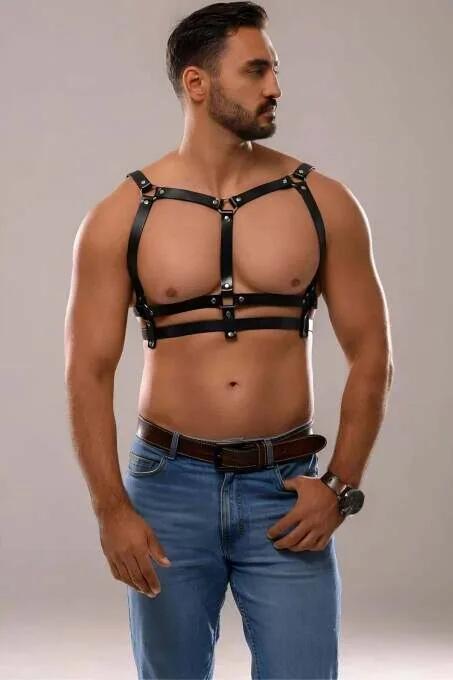 Black faux leather chest harness with silver O-ring hardware and three adjustable bands worn by man