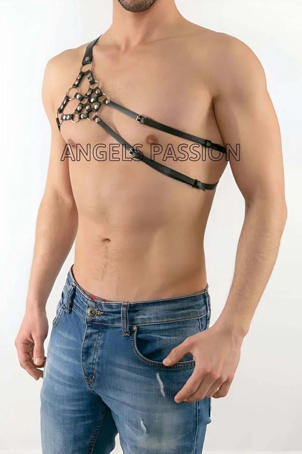 Black faux leather one-shoulder harness with silver dome stud panel and diagonal chest straps on male model