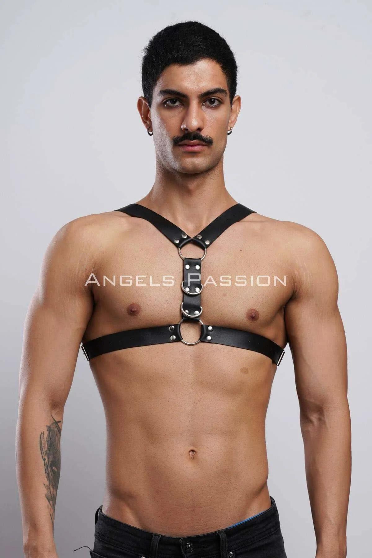 black faux leather chest harness with dual silver O-rings and rivet studs worn on male torso