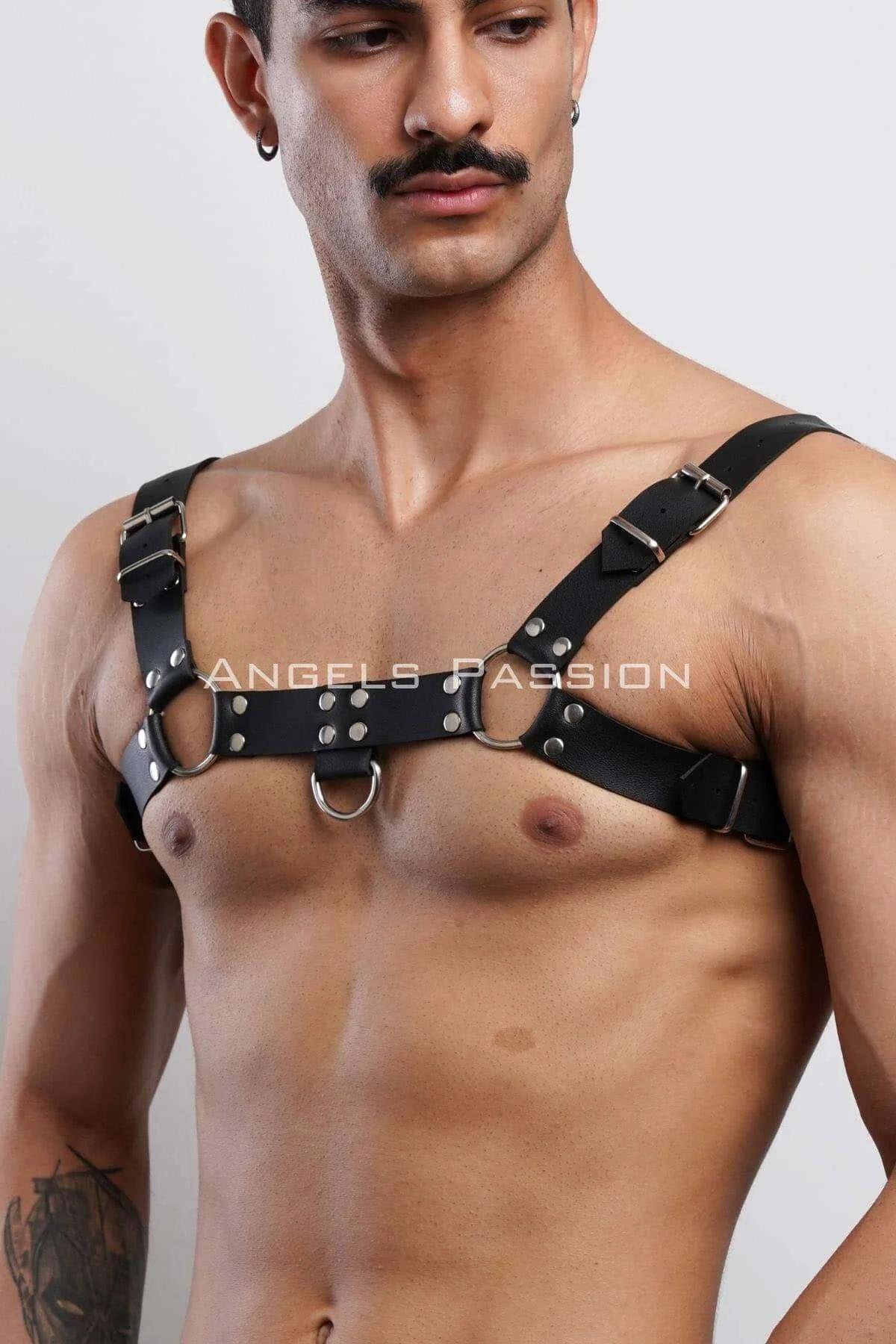 Black faux leather chest harness with three silver O-rings and rivet studs worn by male model