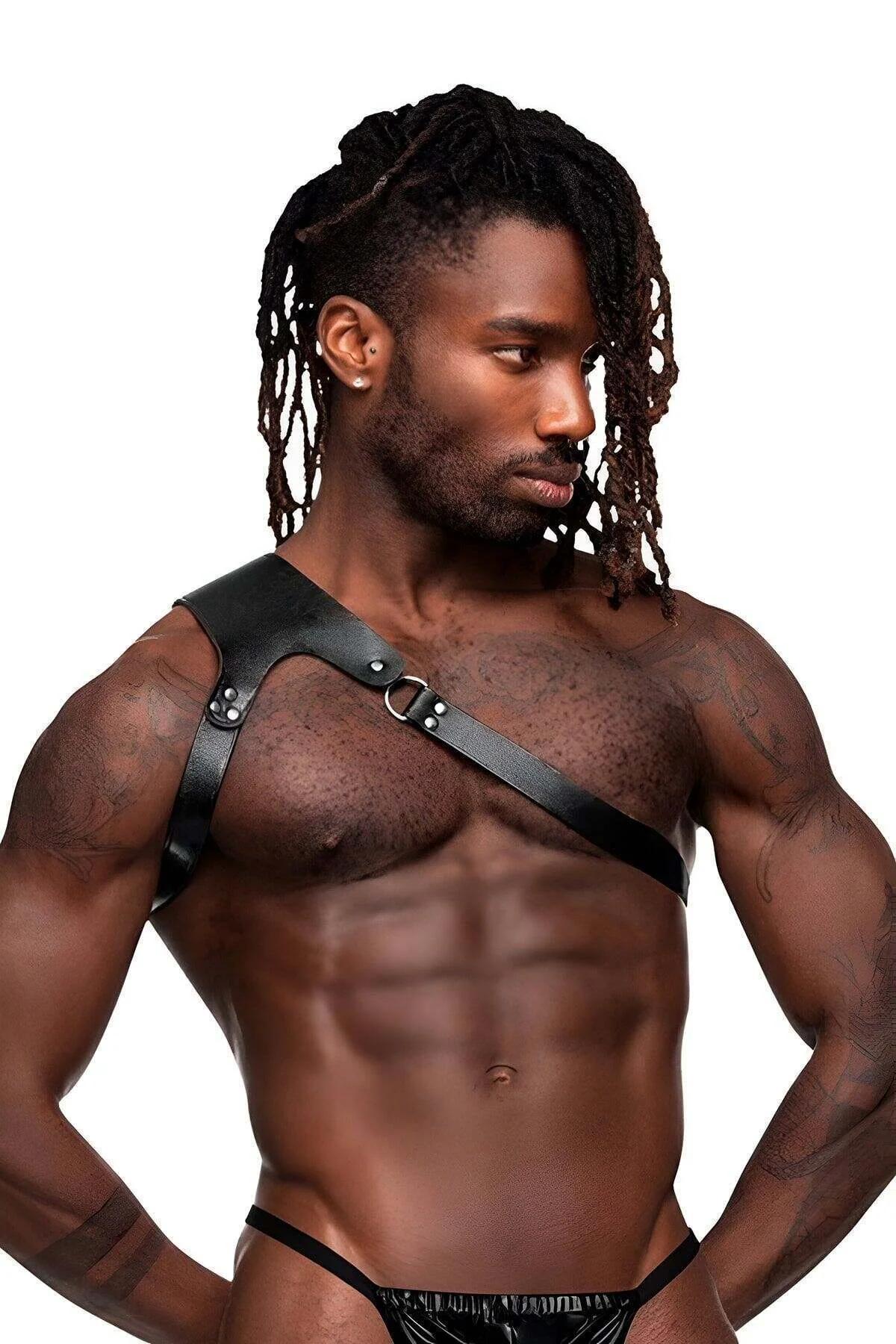 Black faux leather single strap chest harness with brass O-ring and silver rivets worn by male model