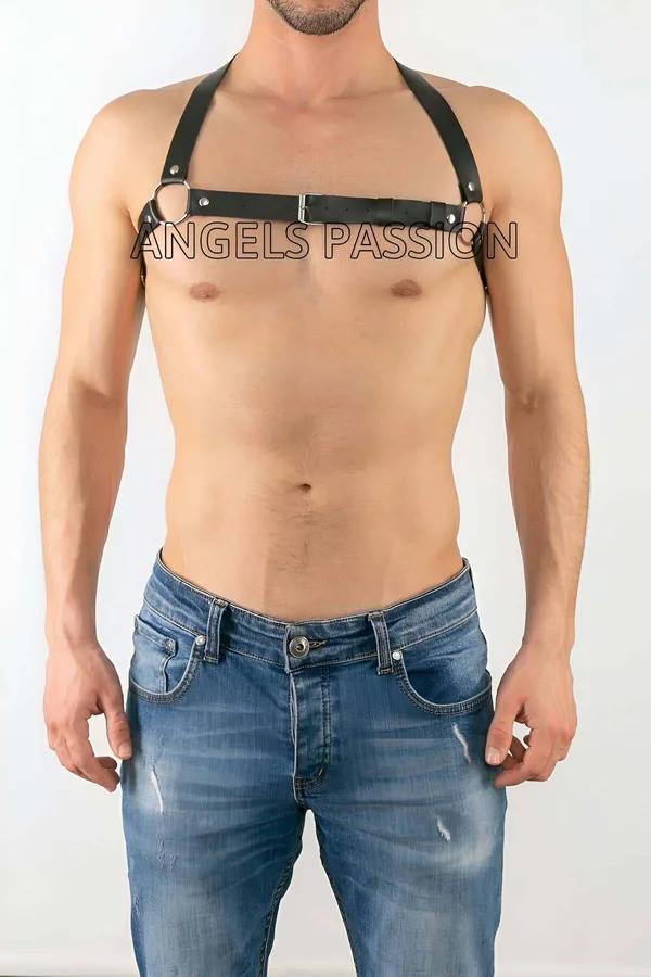 Black faux leather chest harness with central silver O-ring and rectangular buckle worn by male model over bare chest