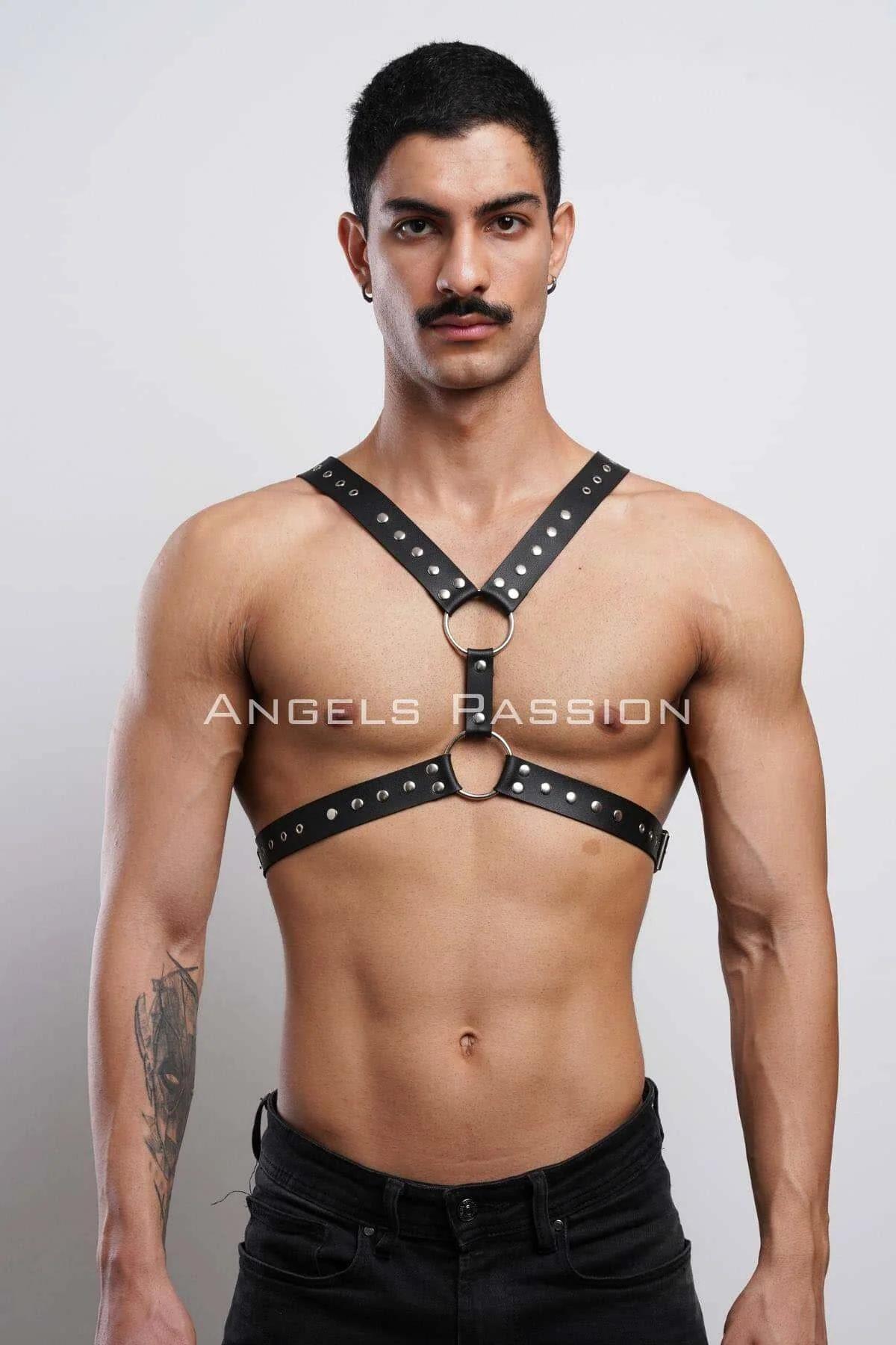 black faux leather studded chest harness with dual silver O-rings worn by male model front view