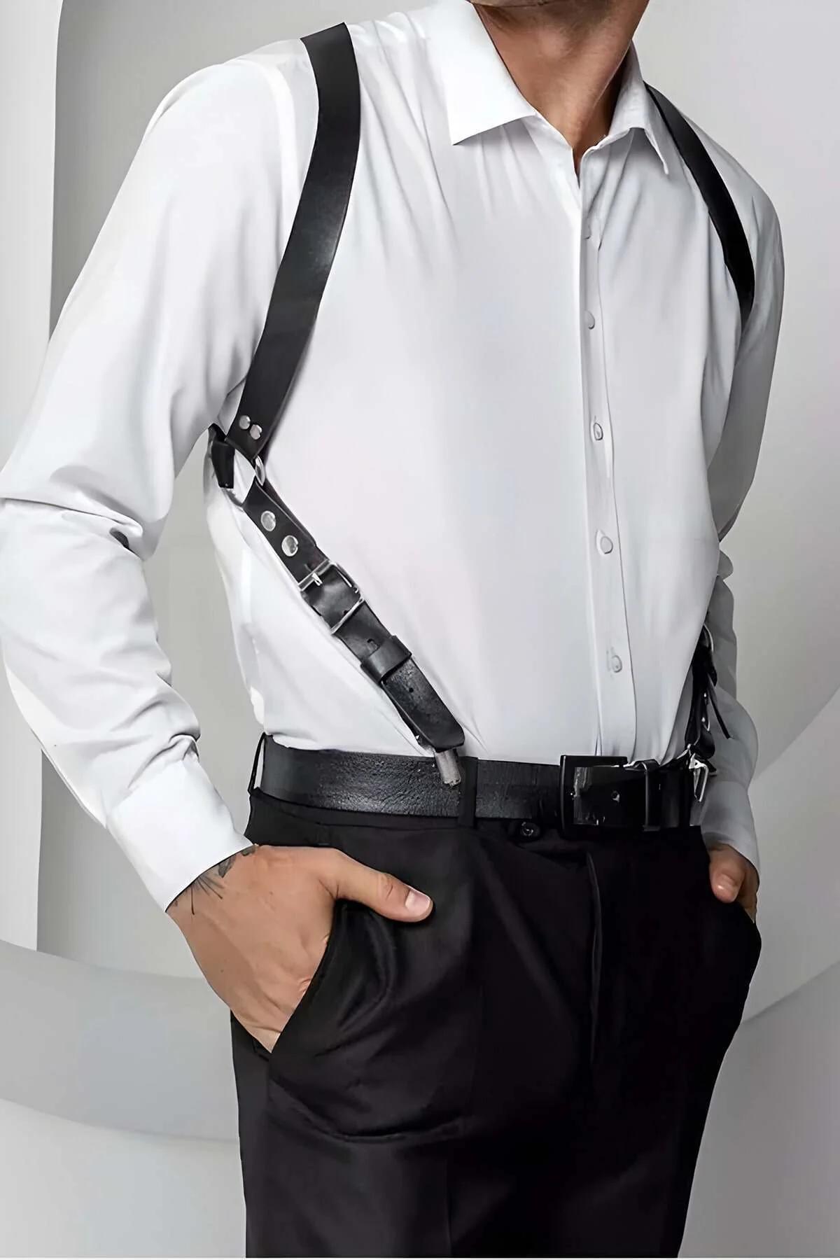 Black faux leather shoulder harness with silver buckles worn over white dress shirt, diagonal strap design
