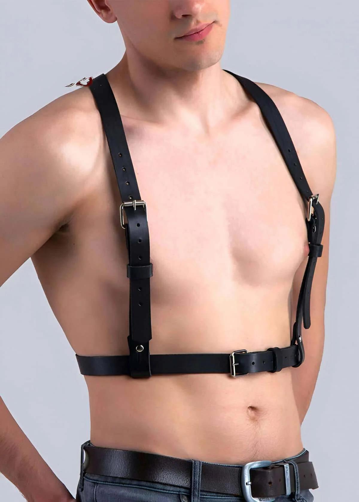 black vegan leather adjustable chest harness with four silver buckle straps worn by male model over bare torso