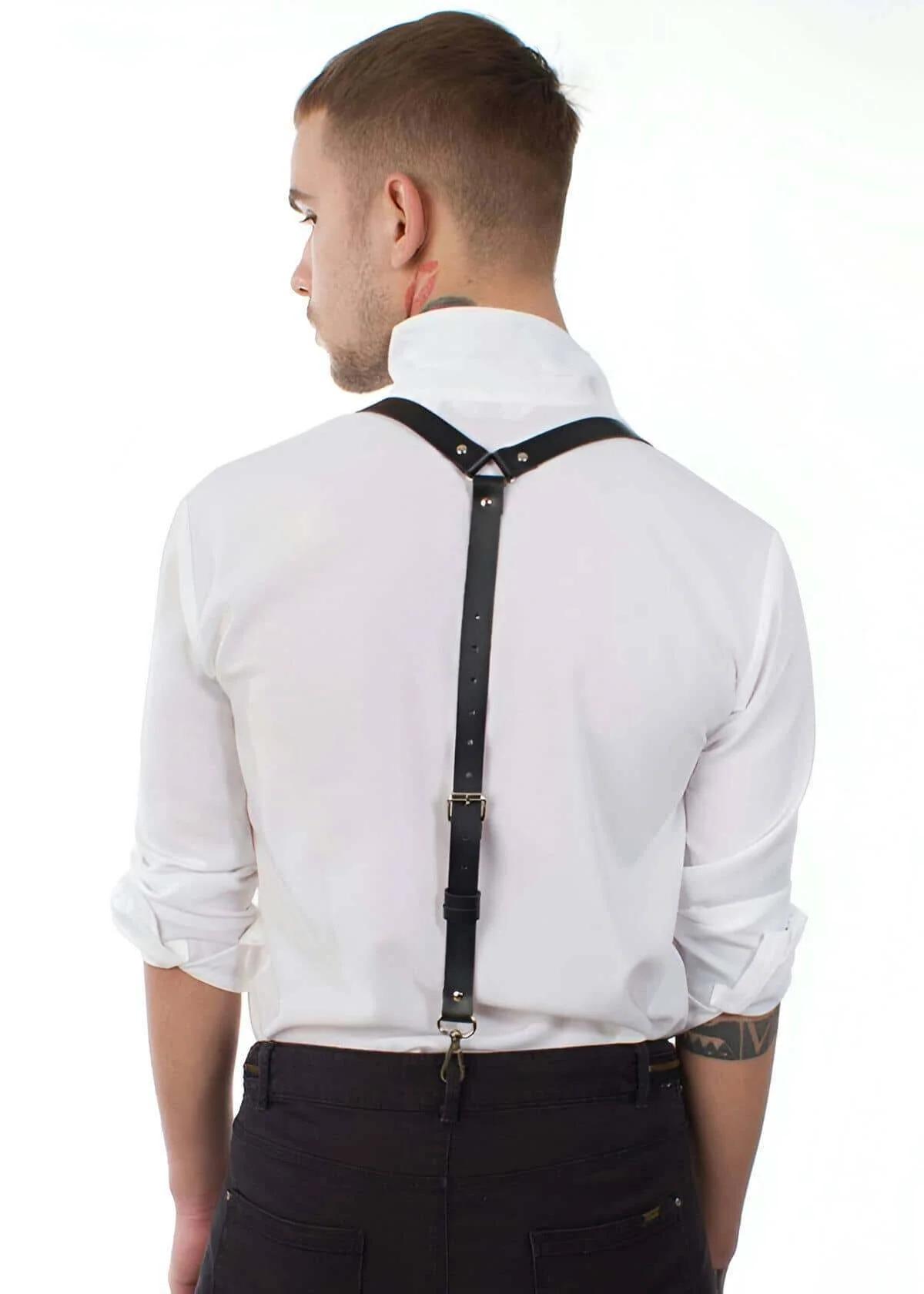 black faux leather Y-back suspender harness with gold-tone hardware worn over white dress shirt, rear view