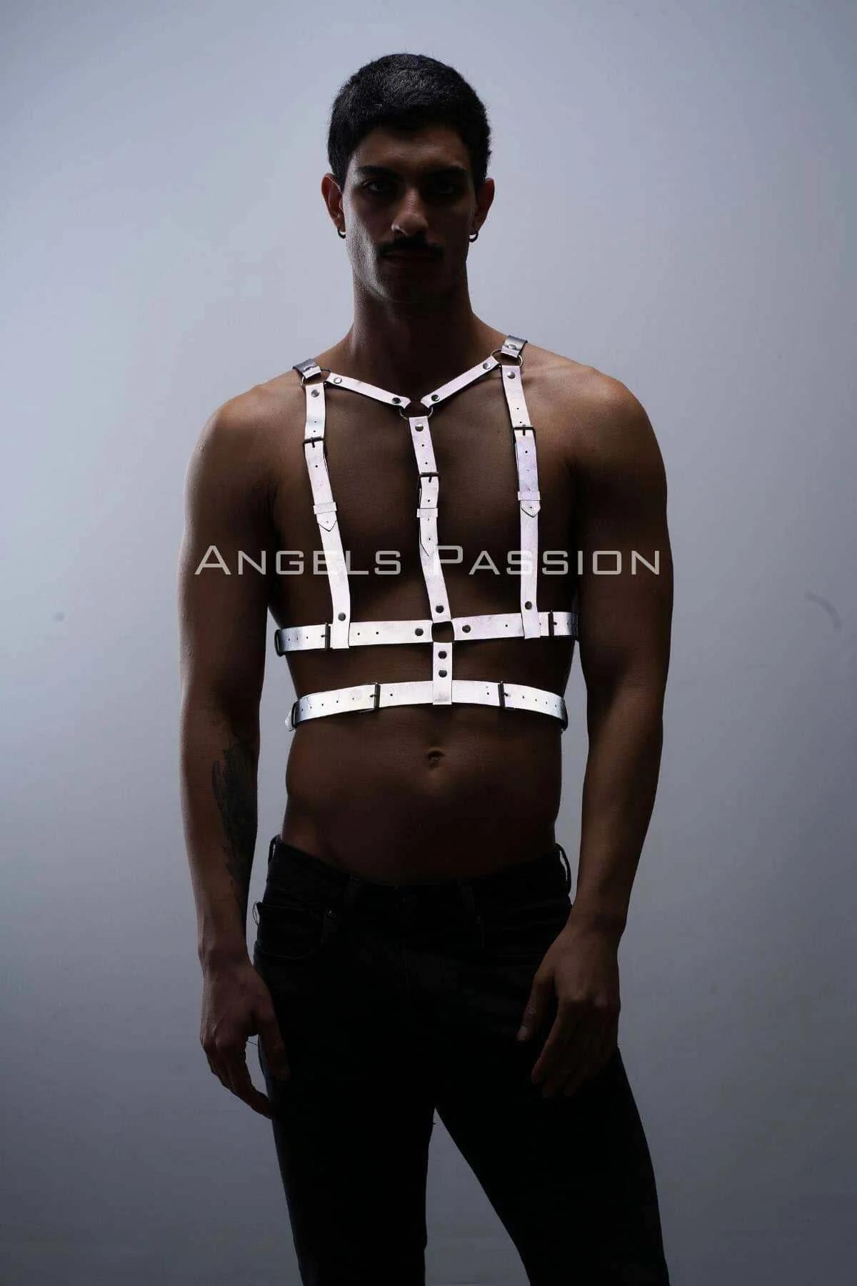White reflective chest harness with silver buckles on male model, adjustable Y-frame strap design over bare chest
