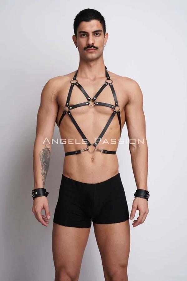 black faux leather body harness with silver O-rings and matching wrist cuffs worn by male model