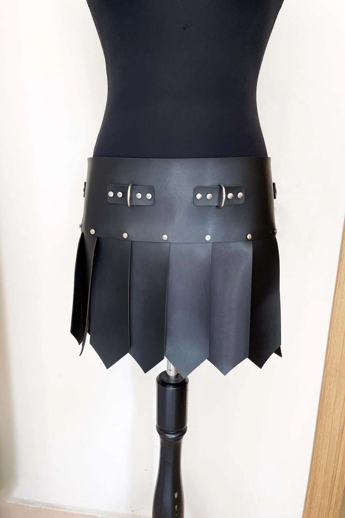 black faux leather gladiator waist skirt harness with silver dome studs and pointed pteryges panels on mannequin