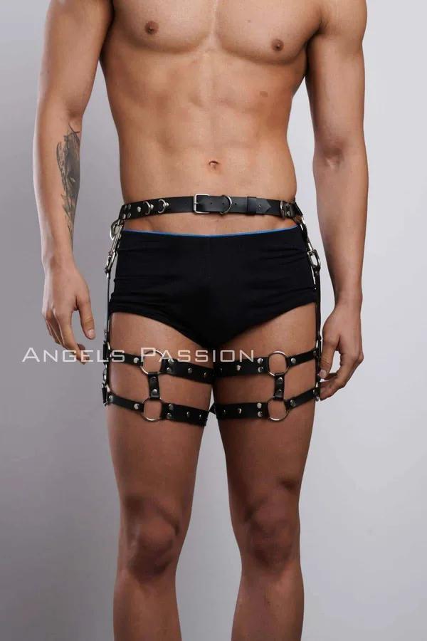 Black faux leather thigh harness with silver O-rings and studs worn over black shorts on male model